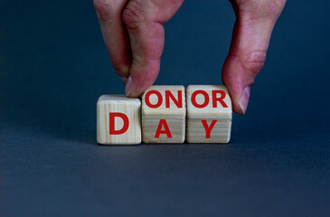 Donor day symbol. Doctor turns wooden cubes with words 'Donor day'. Beautiful grey background. Donor day and medical concept. Copy space.