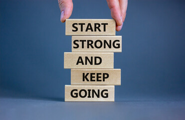 Start strong and keep going symbol. Concept words 'Start strong and keep going' on wooden blocks on...