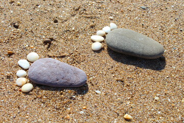 Pebble Stones feet, footprint on sea sand desert surface, happy feet on the beach.