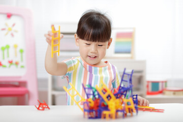 young girl playing balance chairs  toy for homeschooling