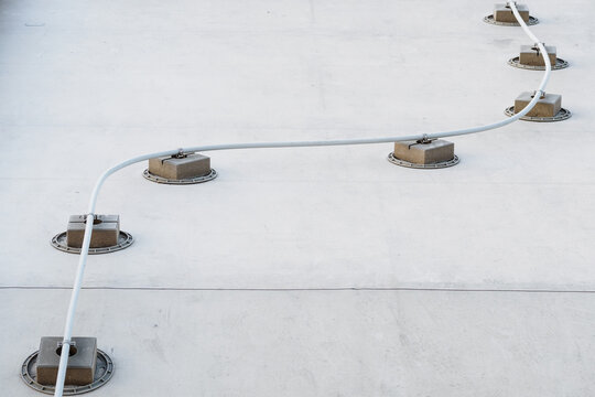 Lightning conductor on a concrete footing.
