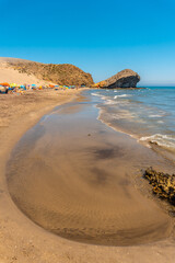Monsul beach in Cabo de Gata Natural Park, eroded lava formations that surround it, fine sand and crystal clear water. San Jose, Almeria. Spain