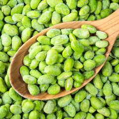 frozen Edamame soybeans in wooden spoon closeup