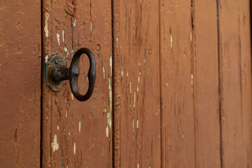 old vintage brown wooden door with metal handle
