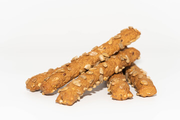 Homemade breadsticks with sunflower seeds isolated on white 