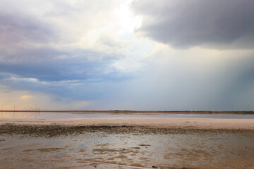 Dark storm clouds over a salt lake before a rain