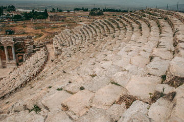 Ancient Roman amphitheater made of stone under the open sky in Pamukkale in Turkey