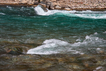 Fast river with rapids high in the mountains