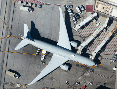 Qatar Airways Boeing 777 at Los Angeles (USA) Airport terminal connected to jet bridges for efficient boarding process. Inbound from Doha, Qatar.