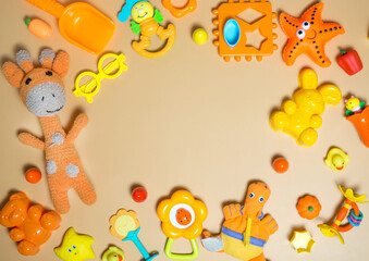 Children's children's toys frame. A set of colorful orange toys on an orange background. Top view, flat layout