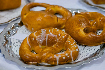 Freshly baked pretzels, kringles on plate at cuisine of cafe, restaurant or bakery. Pastry, pastry, culinary, gastronomy and food concept