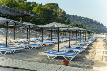 Row of empty sun loungers on the beach in Kemer Antalya