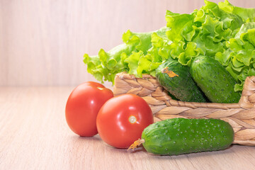 vegetables tomatoes cucumbers and cabbage in a basket on a wooden background