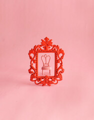 Pink antique chair inside of  red ornamental frame. Eclectic style. Creative contemporary art...