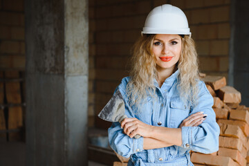 Warehouse woman worker. Woman builder in hardhat. Girl engineer or architect. Home renovation. Quality inspector. Construction job occupation. Construction worker. Lady at construction site.