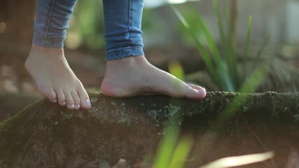 Woman barefoot feet walking outside earthing concept