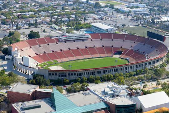 Aerial view of Los Angeles Memorial Coliseum, an Olympic Stadium with a football field. Empty sports stadium stands in California, United States.