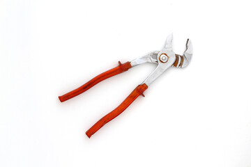 Aerial view old and rusty pliers with red handle in horizontal position isolated on white background. Close up of Old vintage rusty iron clamps.
