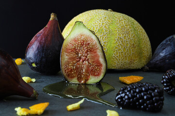 figs on a table with melon