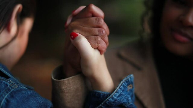 Two diverse friends uniting hands together. Diversity concept