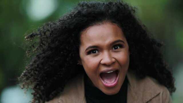 Happy woman WOW reaction. Expressive black girl ecstatic with news