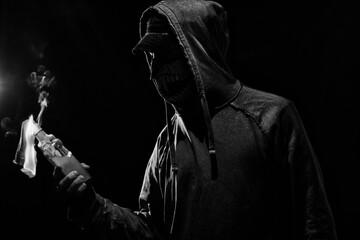 Young man with molotov cocktail