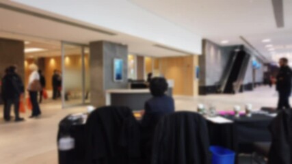 Blurred Left To Right Panorama Of Real Estate Convention In Hotel With People Meeting Up And Suits