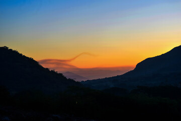 Fototapeta premium A sunset between the mountains of the south coast region