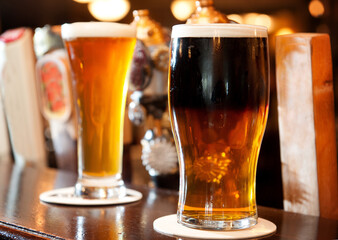 Pints of ale and lager on the bar top of an Irish pub.  Whistler BC, Canada.