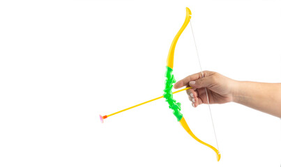 Space for text. Hand holding a toy bow and arrow on white background.
