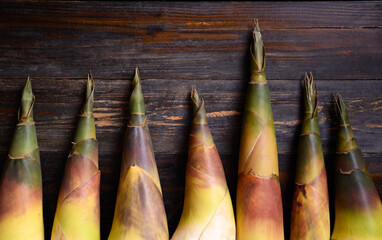 Fresh bamboo shoot on wooden background, Edible vegetable in Asian cuisine