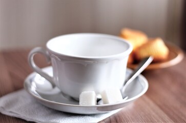 closeup white cup of coffee with spoon and sugar