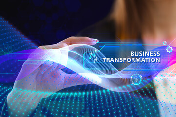 Business, Technology, Internet and network concept. Young businessman working on a virtual screen of the future and sees the inscription: Business transformation