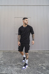 Young man with tattoos in cool casual style