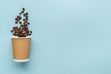 Paper coffee cups with coffee beans. Top view