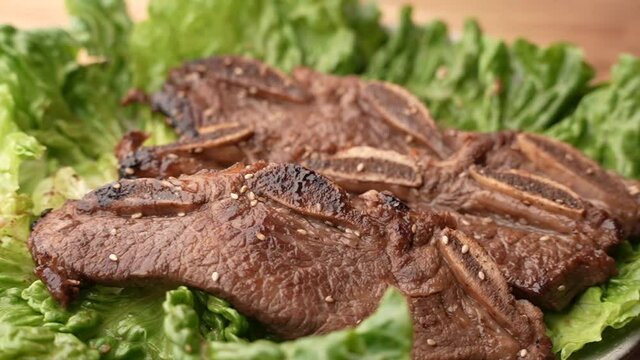 dropping korean style bbq short rib on lettuce slow motion 240p