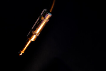 Macro Closeup of Isolated Metal Male Quarter Inch Audio Cable Connector on Black Background