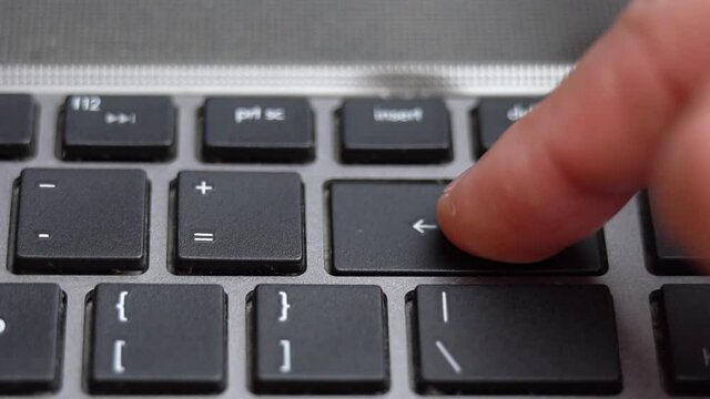 Backspace button pressing on keyboard, laptop keyboard close up