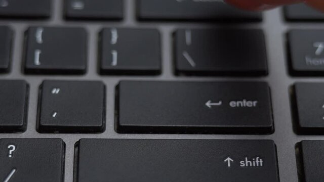 Enter button pressing on keyboard, laptop keyboard close up