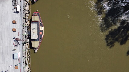 overhead top down view of old steam powered boats running tourists along the Murray river in Echuca, Victoria, Australia