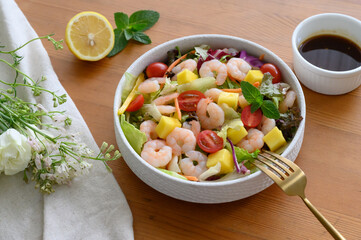 Fresh mango shrimp salad on the table