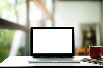 Fototapeta premium Front view of the laptop on the work desk in the office blur background. 