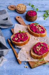 Three sandwiches with beetroot paste