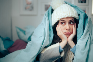 Unhappy Woman Feeling Cold Wearing Warm Winter Clothes Indoors - obrazy, fototapety, plakaty