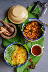 Homemade traditional Peranakan Malaysian cuisine / Nasi Kunyit aka Turmeric Glutinous Rice / Delicious dish eaten with dry curry chicken with glutinous rice cooked in coconut milk and turmeric