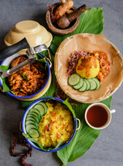 Homemade traditional Peranakan Malaysian cuisine / Nasi Kunyit aka Turmeric Glutinous Rice / Delicious dish eaten with dry curry chicken with glutinous rice cooked in coconut milk and turmeric