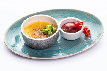 Dessert creme brulee and red currant sauce 
