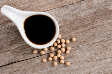 soy sauce and soybean on wood table/