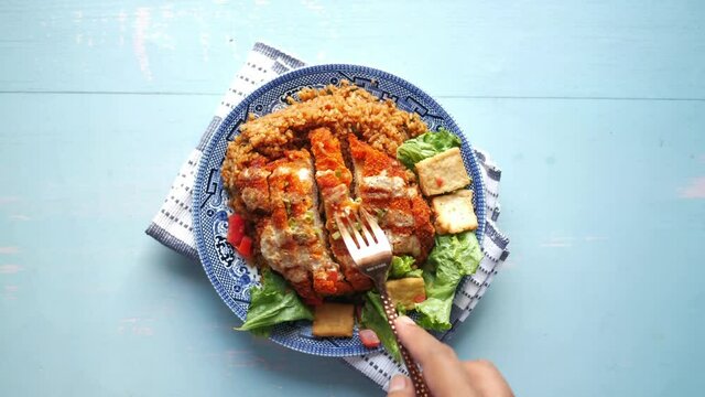 slice of chicken meat, rice and fresh vegetable salad on table.