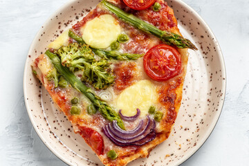 pie with asparagus on the plate. Homemade tart with asparagus wrapped with bacon, spinach, cherry tomatoes and cheese. Food recipe background. Close up